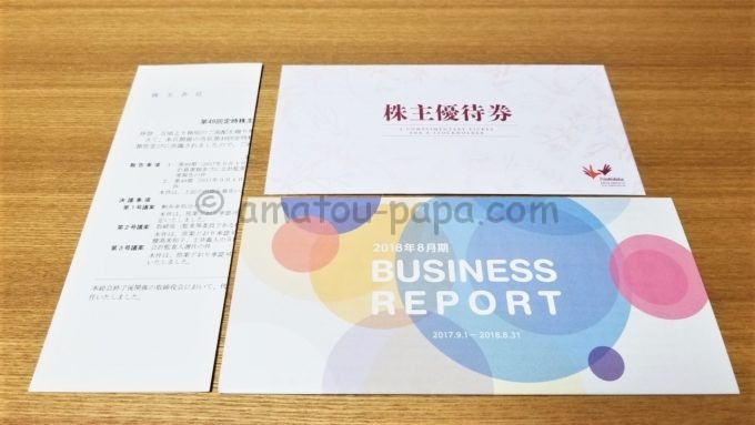 株式会社コシダカホールディングスの「BUSINESS REPORT」と「株主優待券と書かれた封筒」
